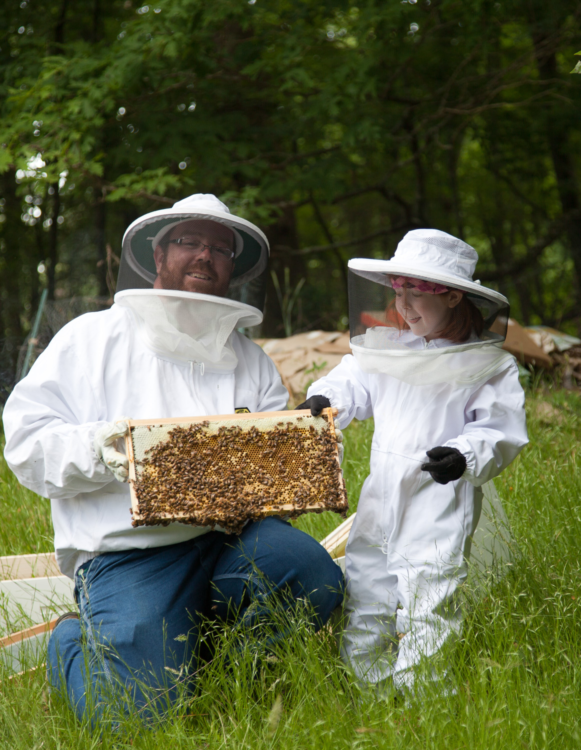 Will Thomas with daughter Kaiya Thomas in Mills River NC working with Honey Bees