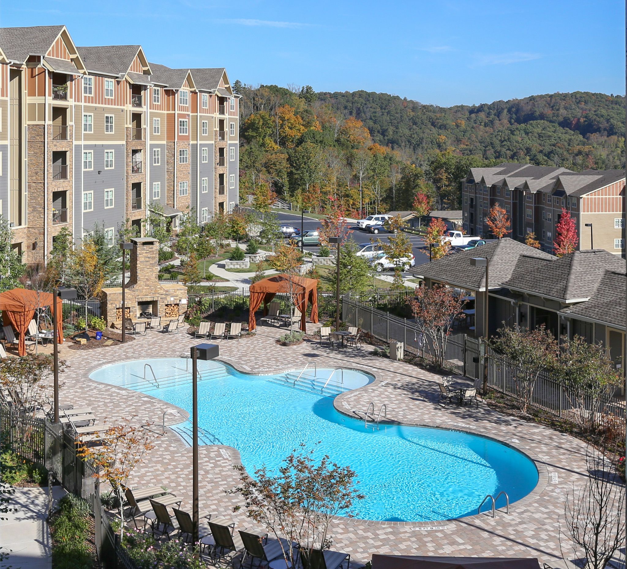 Commercial photography of The Aventine apartments in Asheville, NC. View shooting down on the pool looking out over the blue ridge mountains.