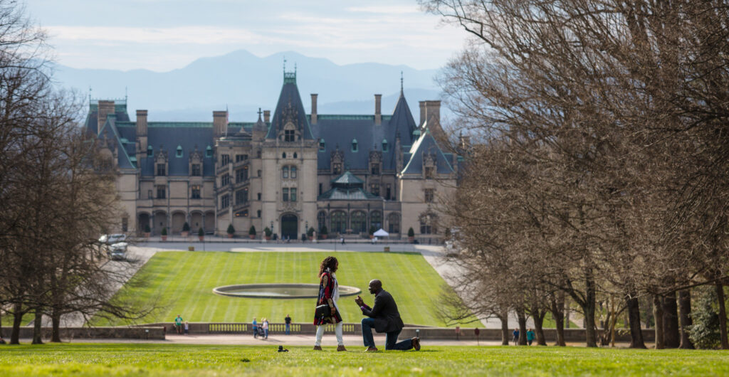 Proposal happening on Diana Hill with Biltmore Estate in the background