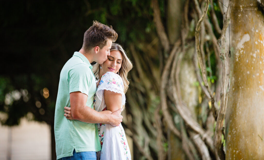 Gage couple embracing under the vines at Biltmore Estate, will you marry me surprise proposal