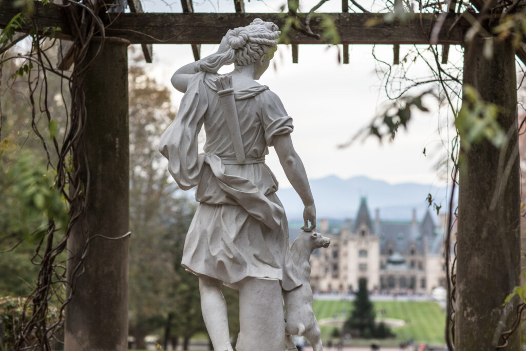 Photo of Diana the goddess of the hunt with Biltmore house in the background.