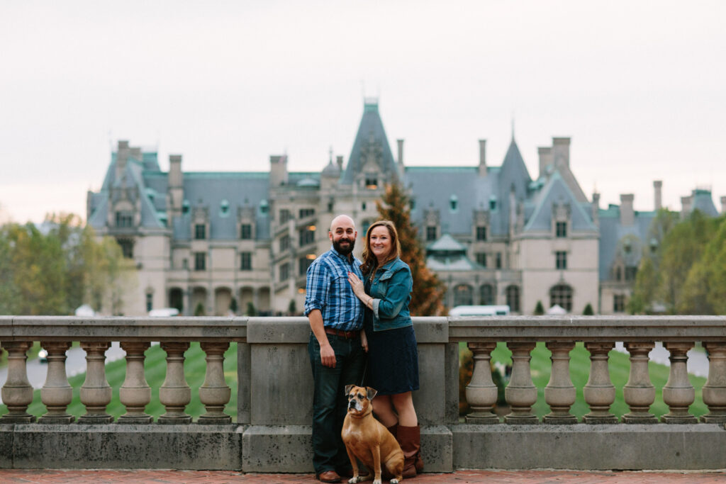 Eileen and Eser standing at the base of Diana lawn with the Biltmore house in the background