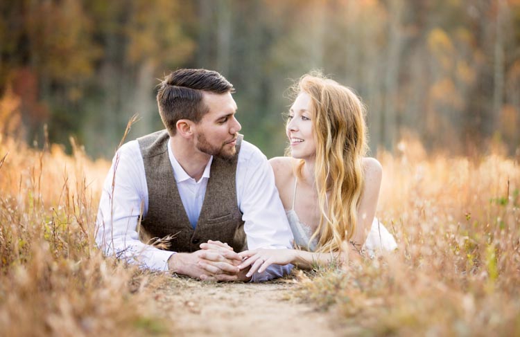 Couple on Engagement Photo session in Dupont State Forest laying in the grass