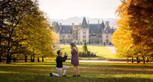 Austin taking a knee on Diana Hill at the Biltmore Estate in Asheville proposing to Marissa