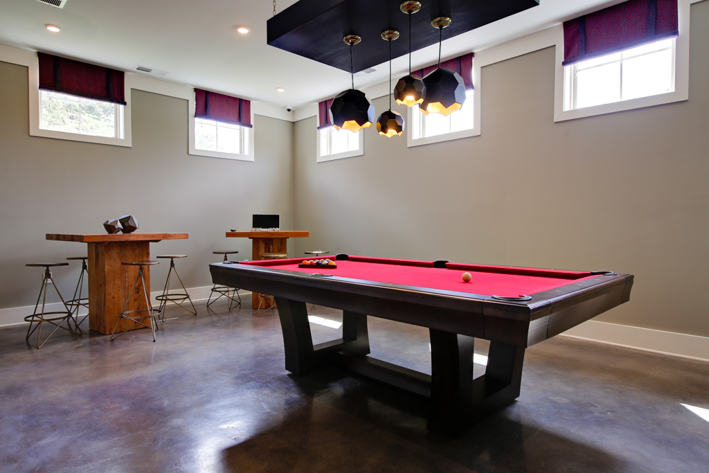 A picture of the gaming room with a pool table in the foreground and gaming tables in the background on this real estate photography shoot.