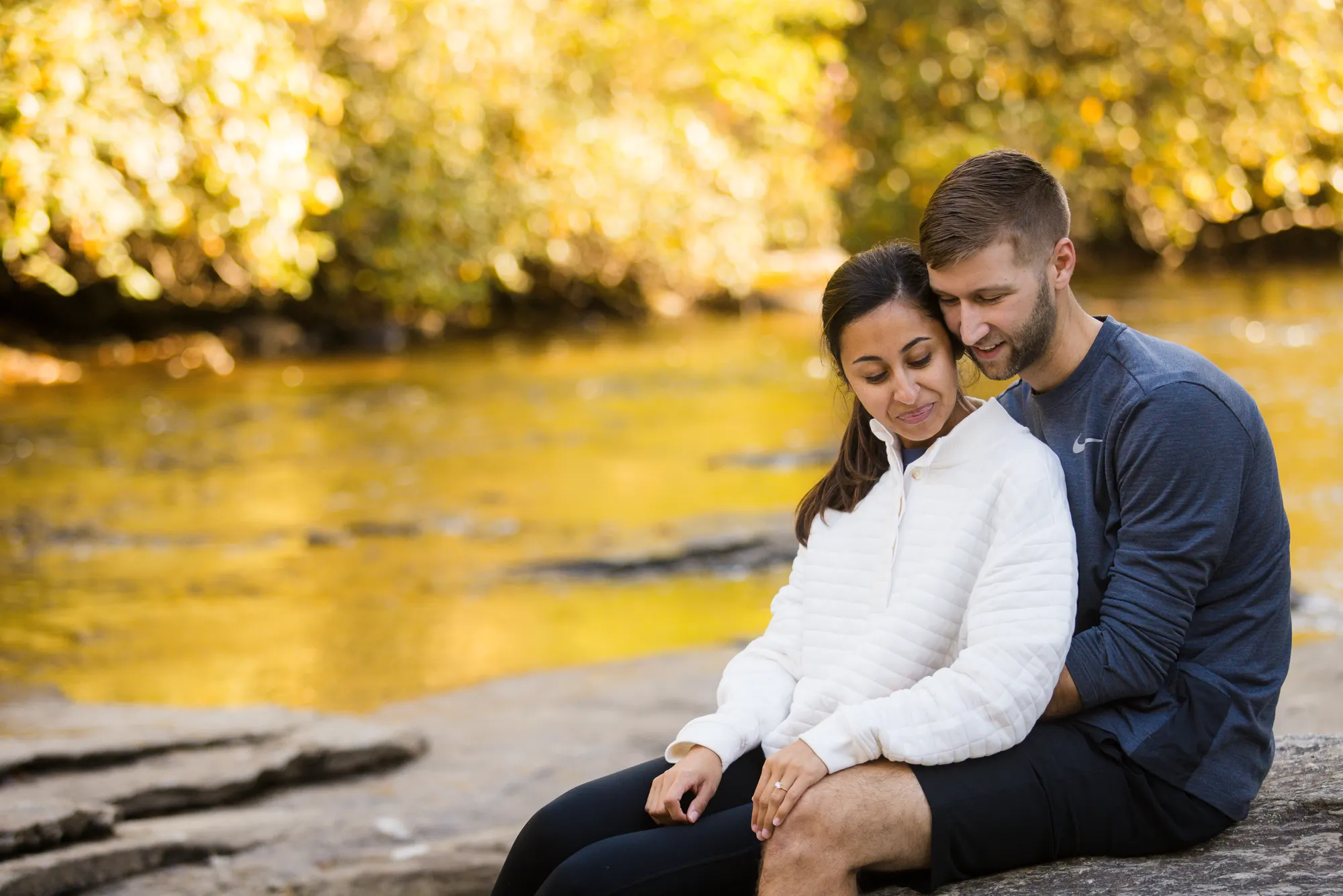 Couple on the riverbank in fall color, DuPont State Forest