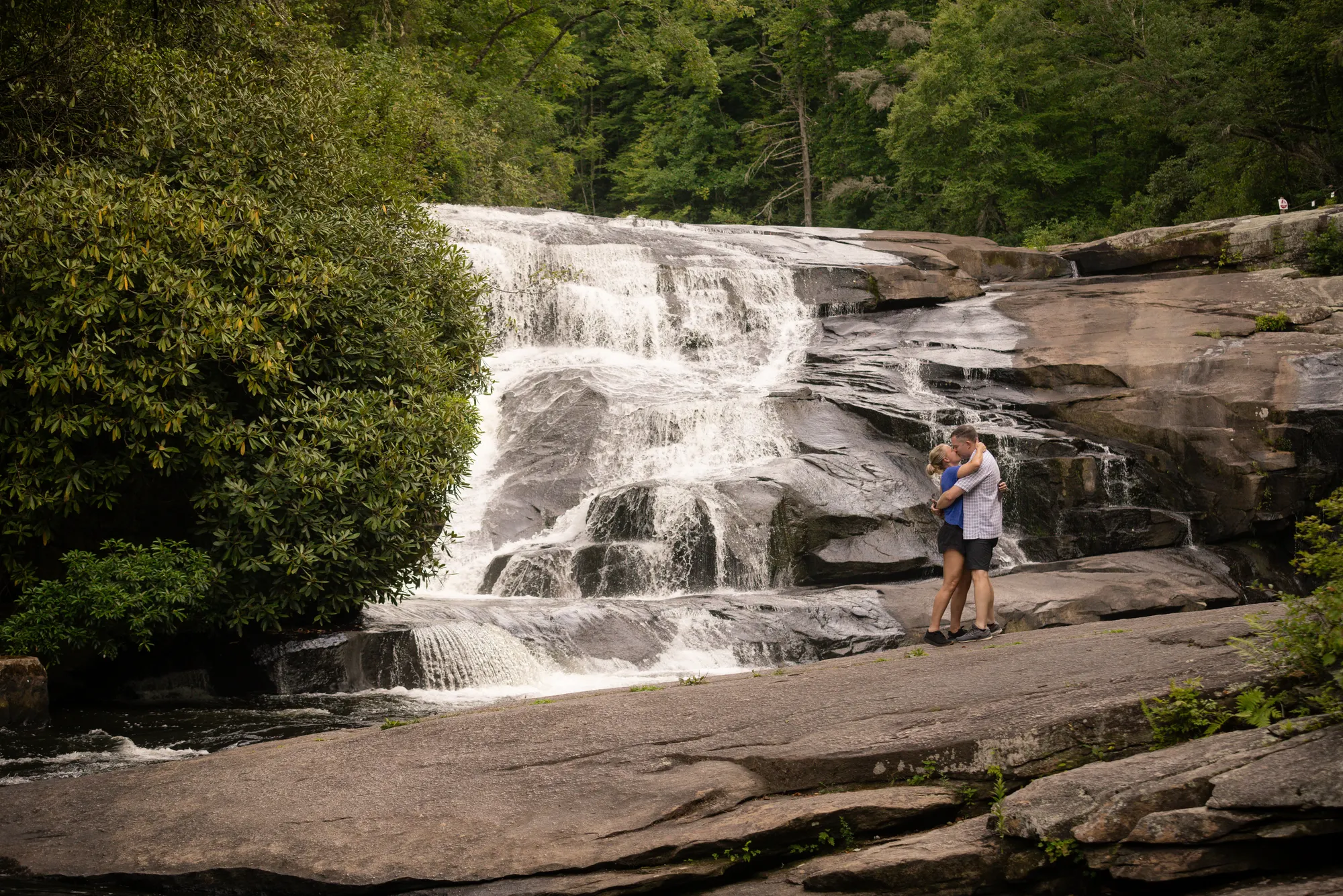 Embrace below the waterfall in summer, DuPont State Forest