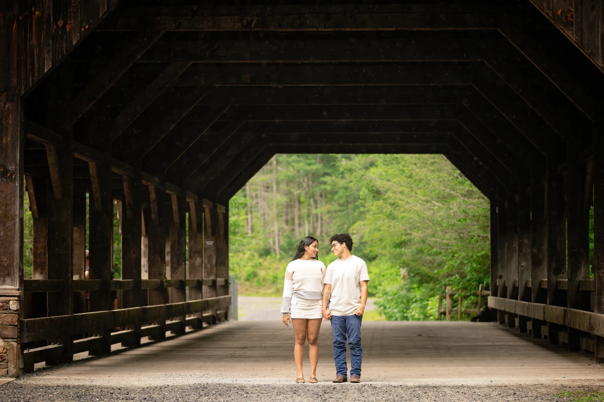 Engagement photos inside the covered bridge at DuPont State Forest