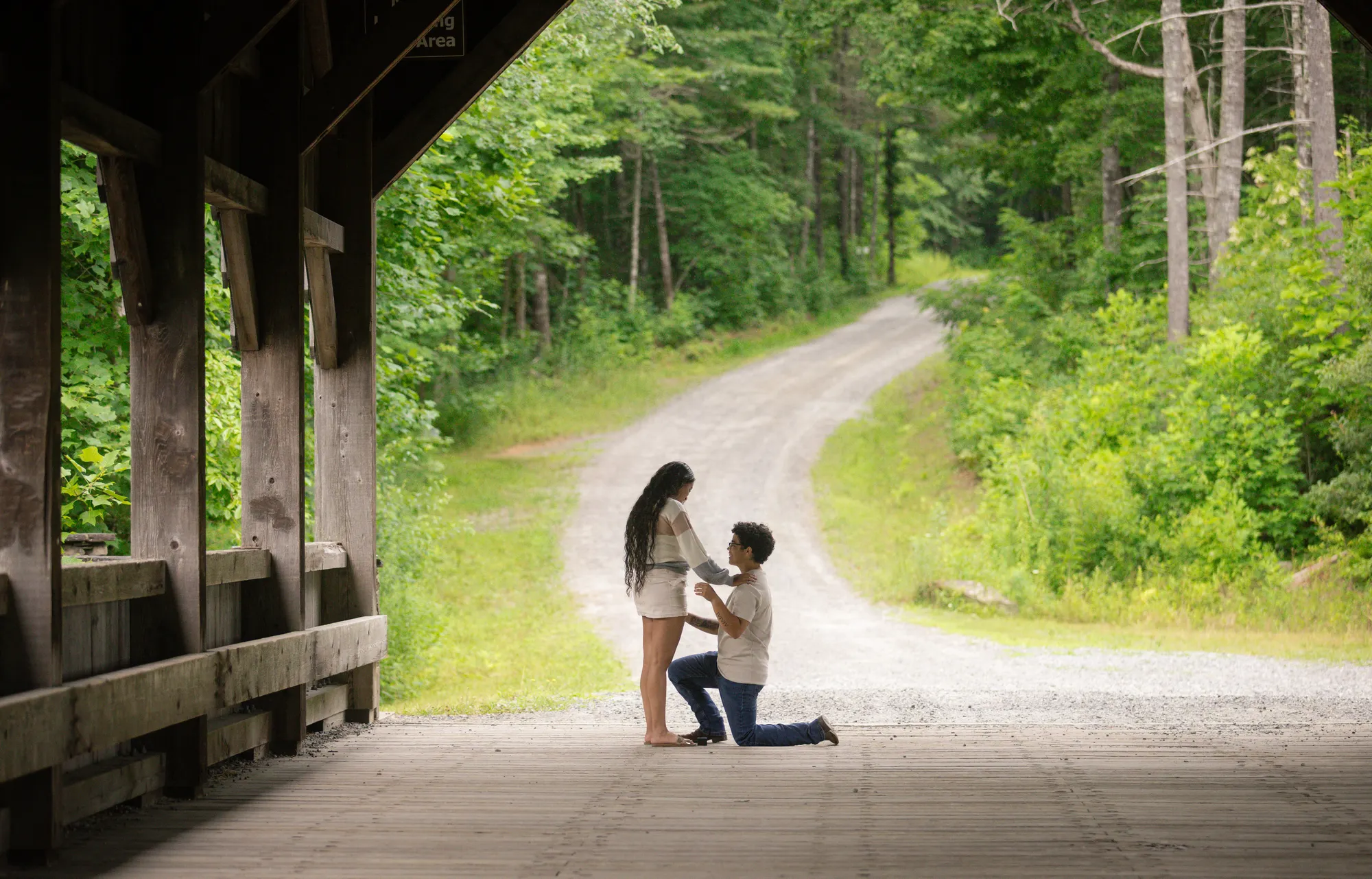 Surprise proposal on one knee inside the covered bridge at DuPont State Forest