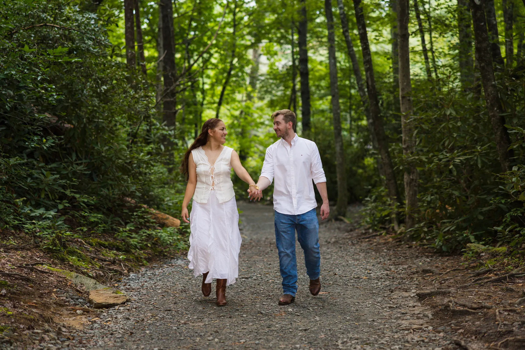 White-dress engagement photos on a DuPont hiking trail