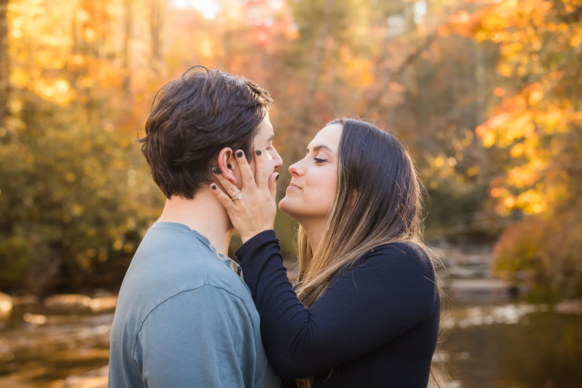 New engagement ring during a kiss at DuPont State Forest in fall