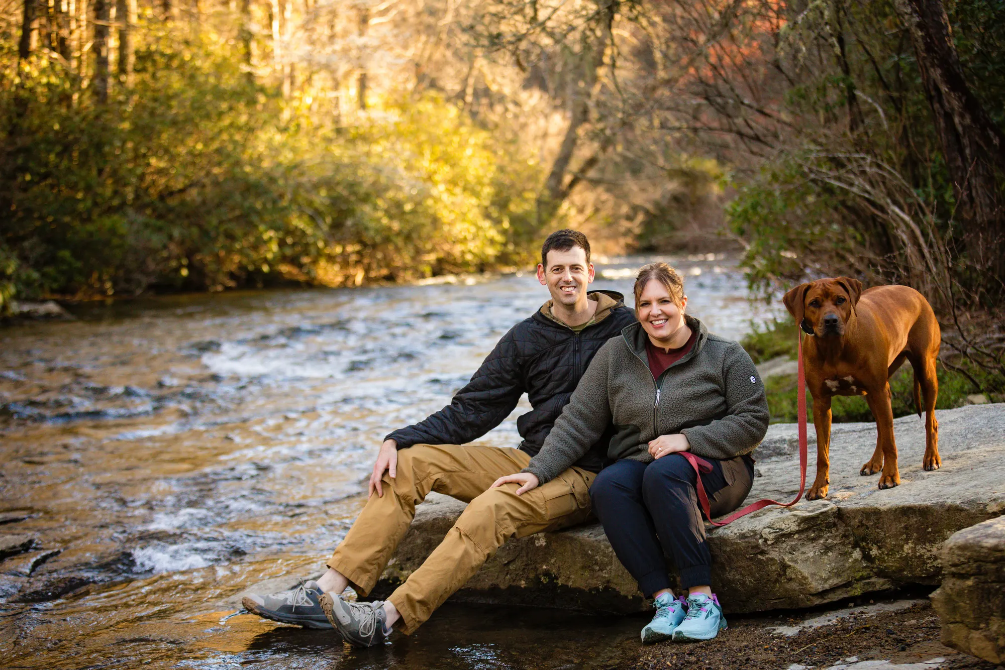 Engagement session by the Little River with the couple's dog, DuPont State Forest