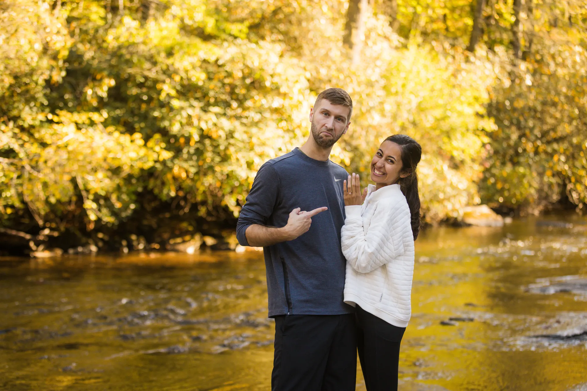 Just-engaged couple showing off the ring at DuPont State Forest