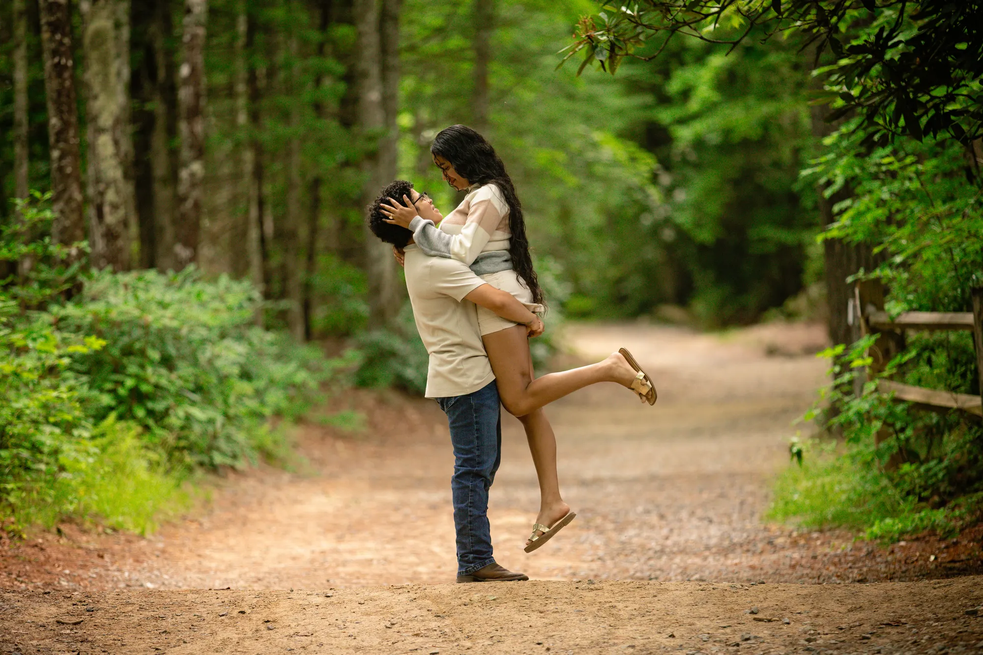 Playful lift on a summer trail, DuPont State Forest engagement session