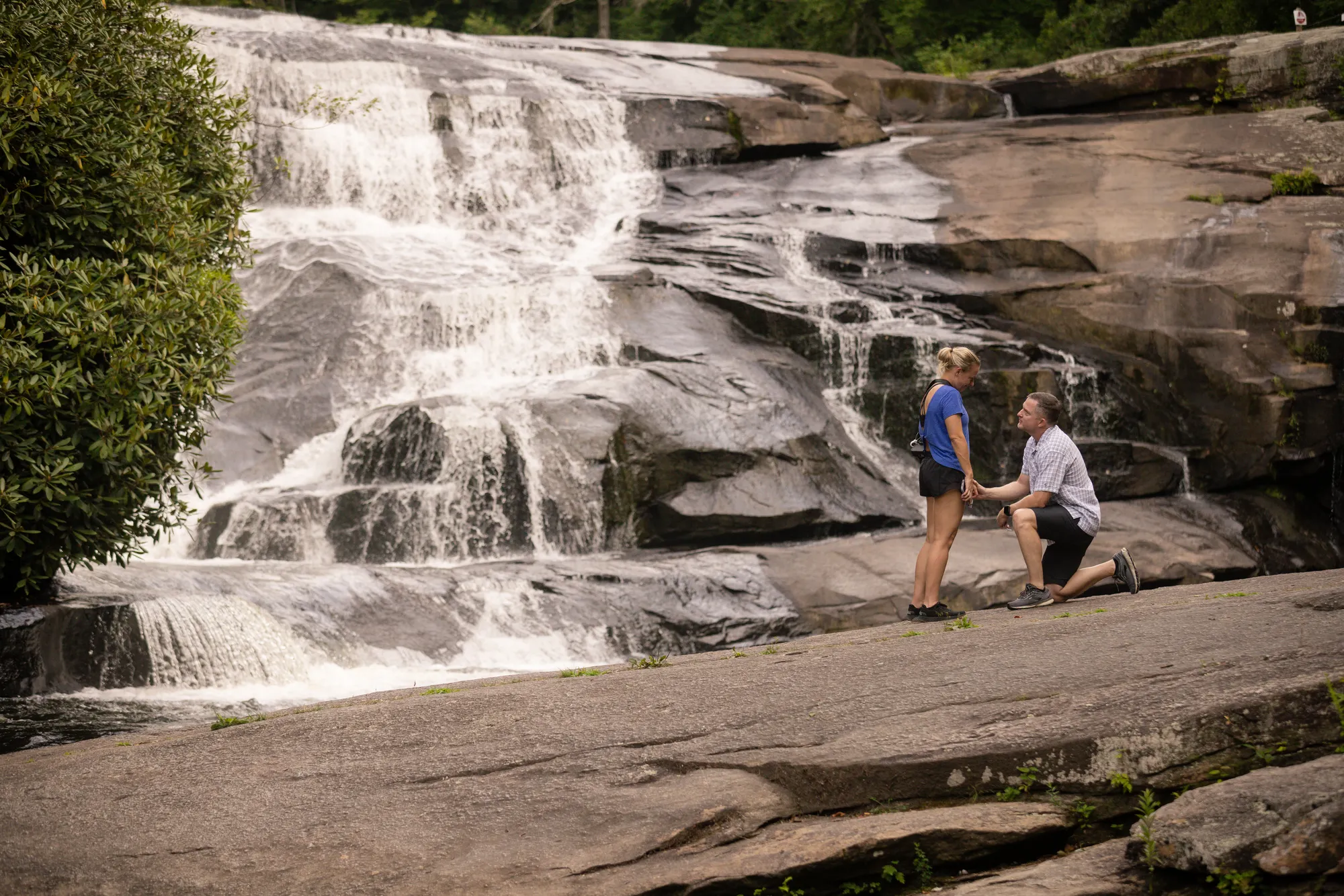 Summer proposal at Triple Falls, DuPont State Forest, high water on the cascade