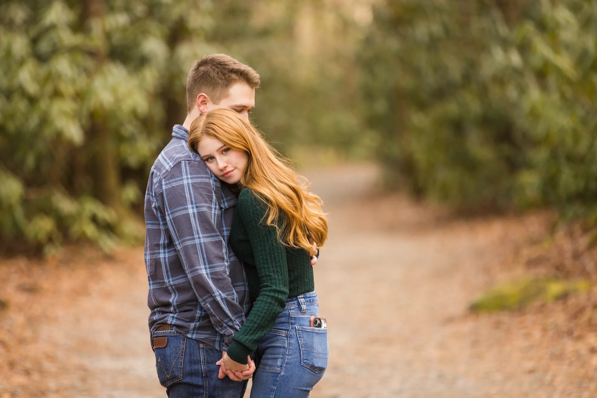 Winter engagement photos on a DuPont State Forest trail