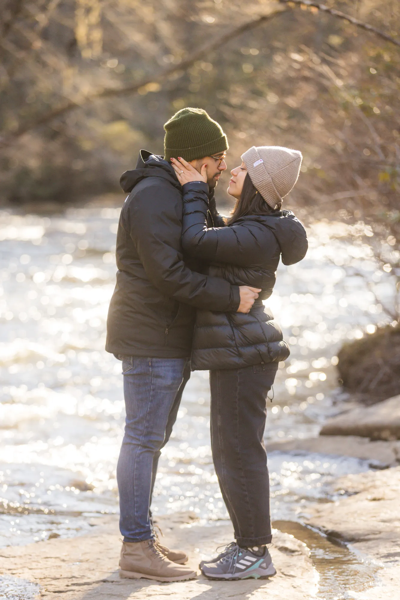 Kiss by the sparkling winter river, engagement session DuPont