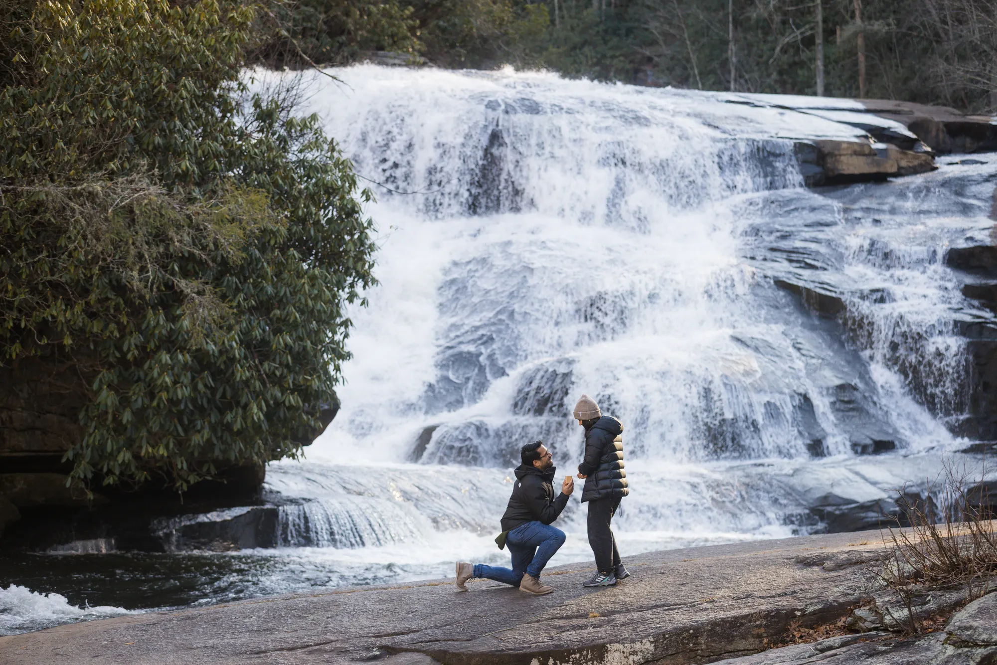 Winter waterfall proposal on one knee, DuPont State Forest