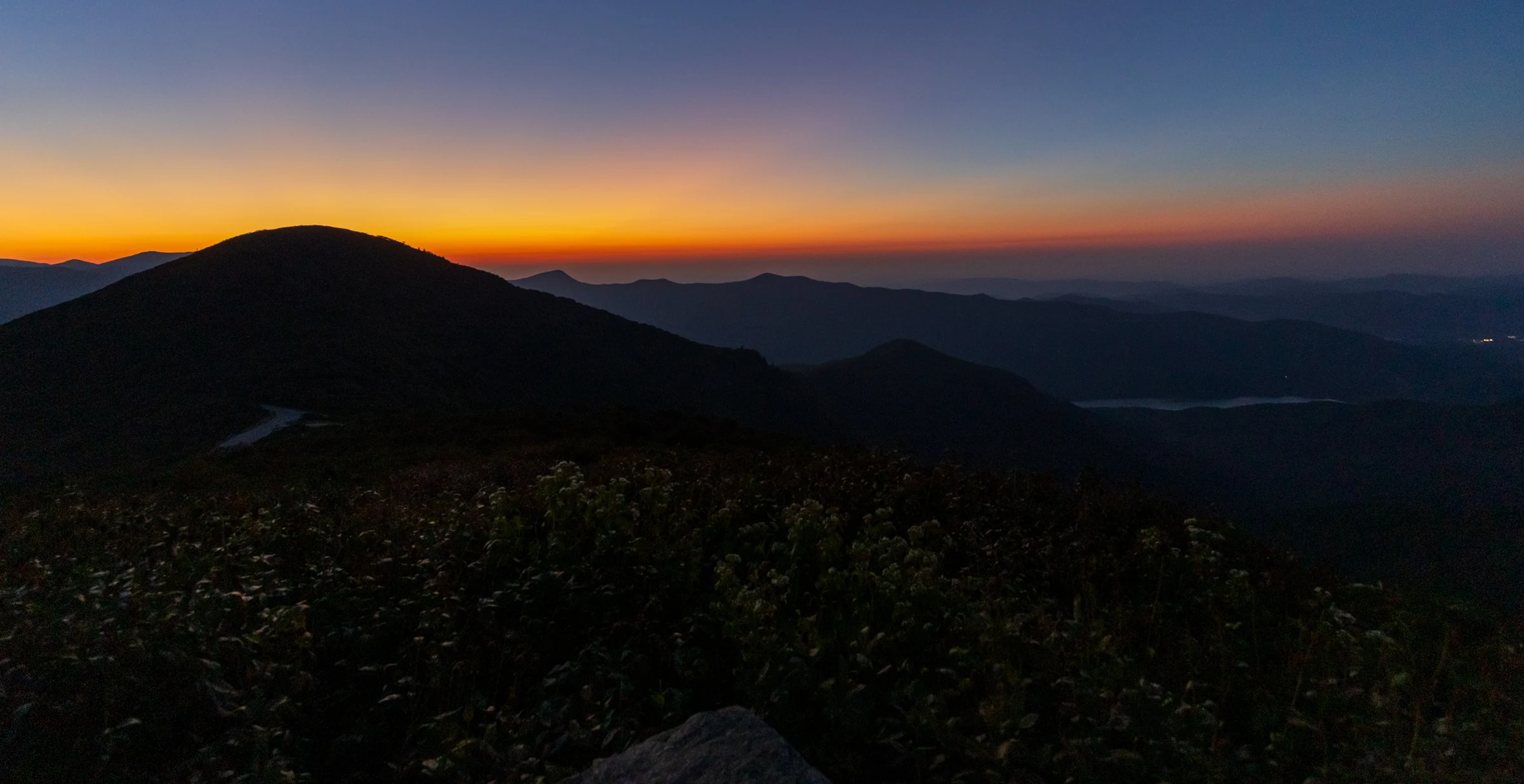 Blue hour over layered mountain ridges seen from Craggy Pinnacle