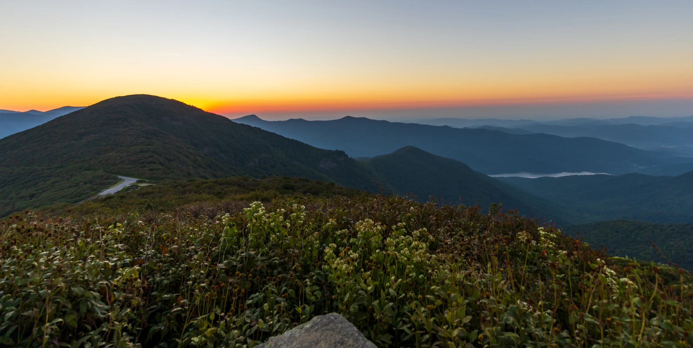 Layered mountain ridges at dawn seen from Craggy Pinnacle with low cloud in the valleys