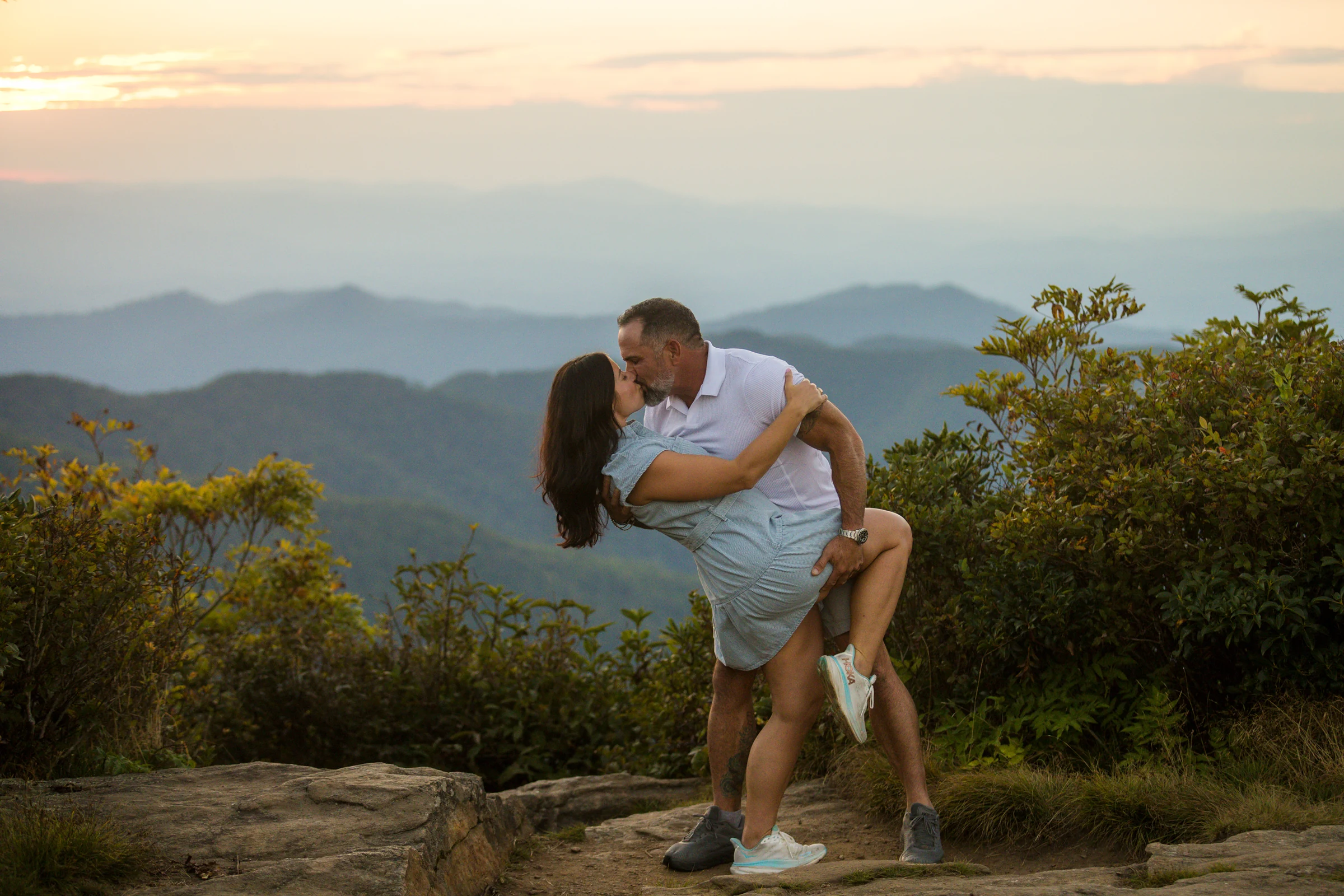 Scott and Jaci kiss during blue hour on Craggy Pinnacle after the sun has set