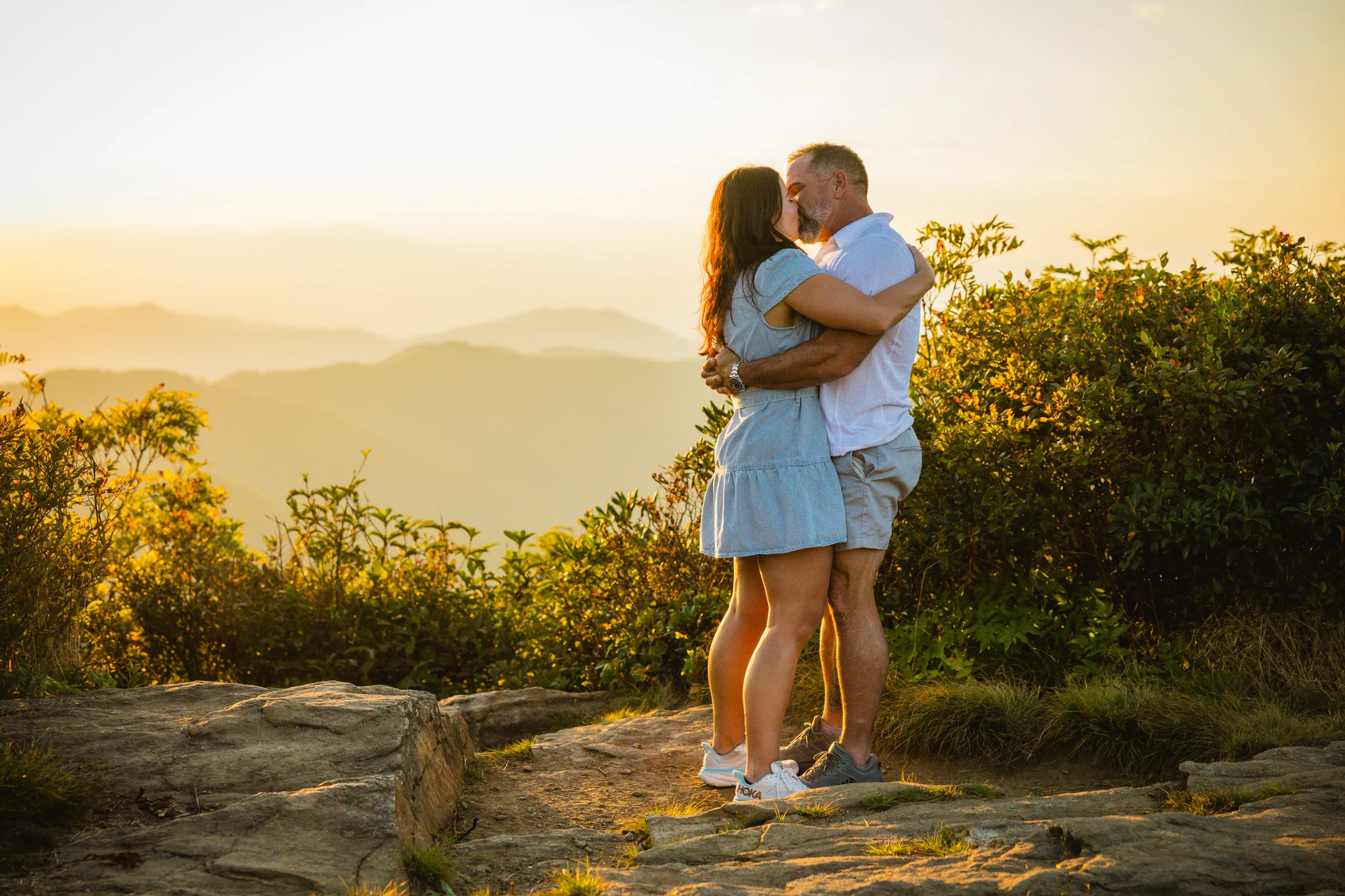 Scott and Jaci's first kiss as an engaged couple on Craggy Pinnacle at sunset, Blue Ridge Parkway, Asheville NC